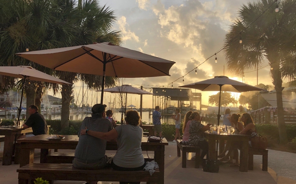 people enjoying outdoor dining during sunset in baldwin county