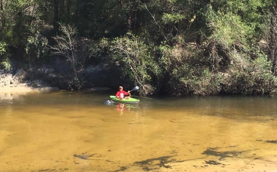 young boy kayaking in baldwin county river